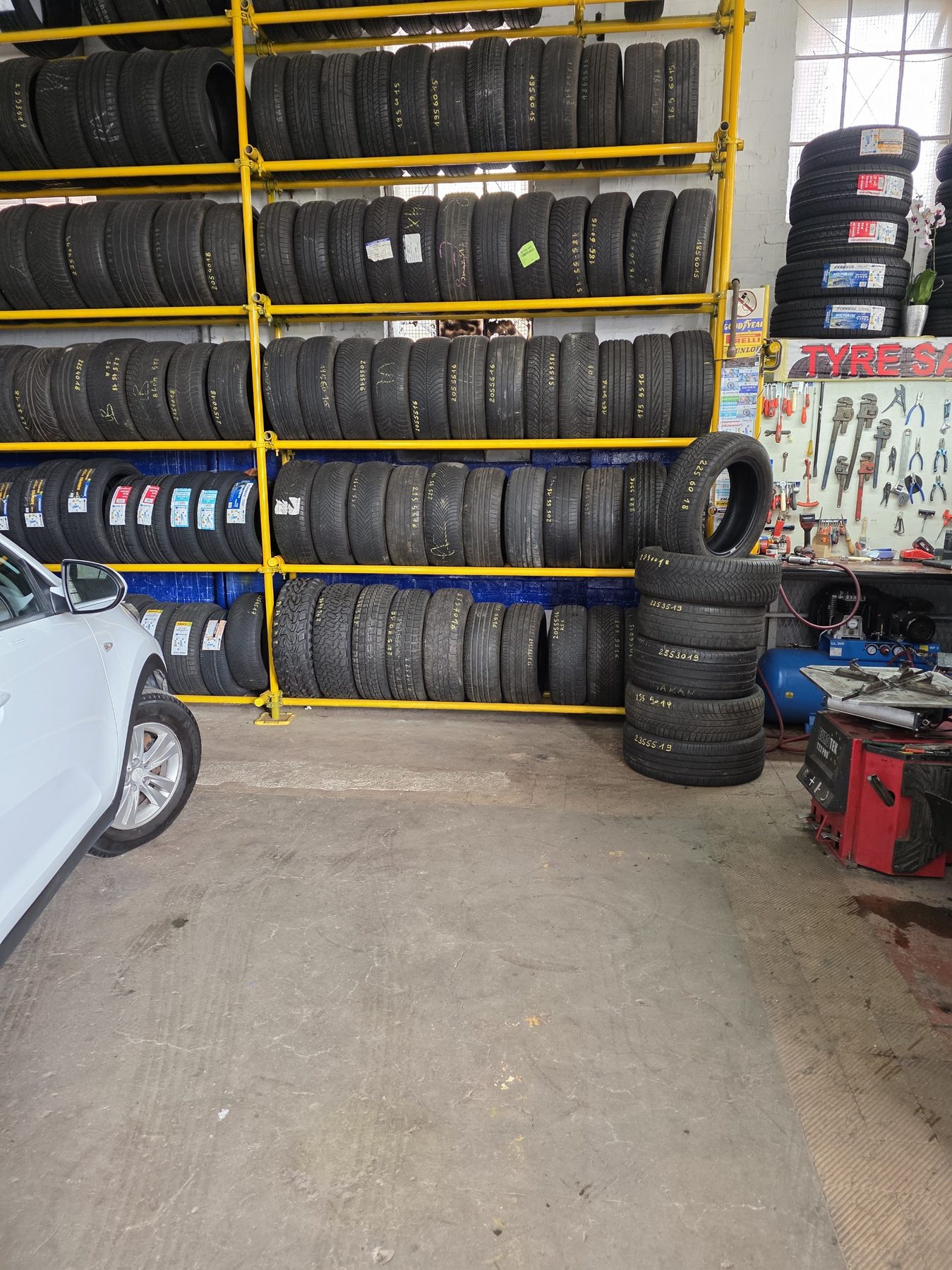Tyre stock wall with tool pegboard