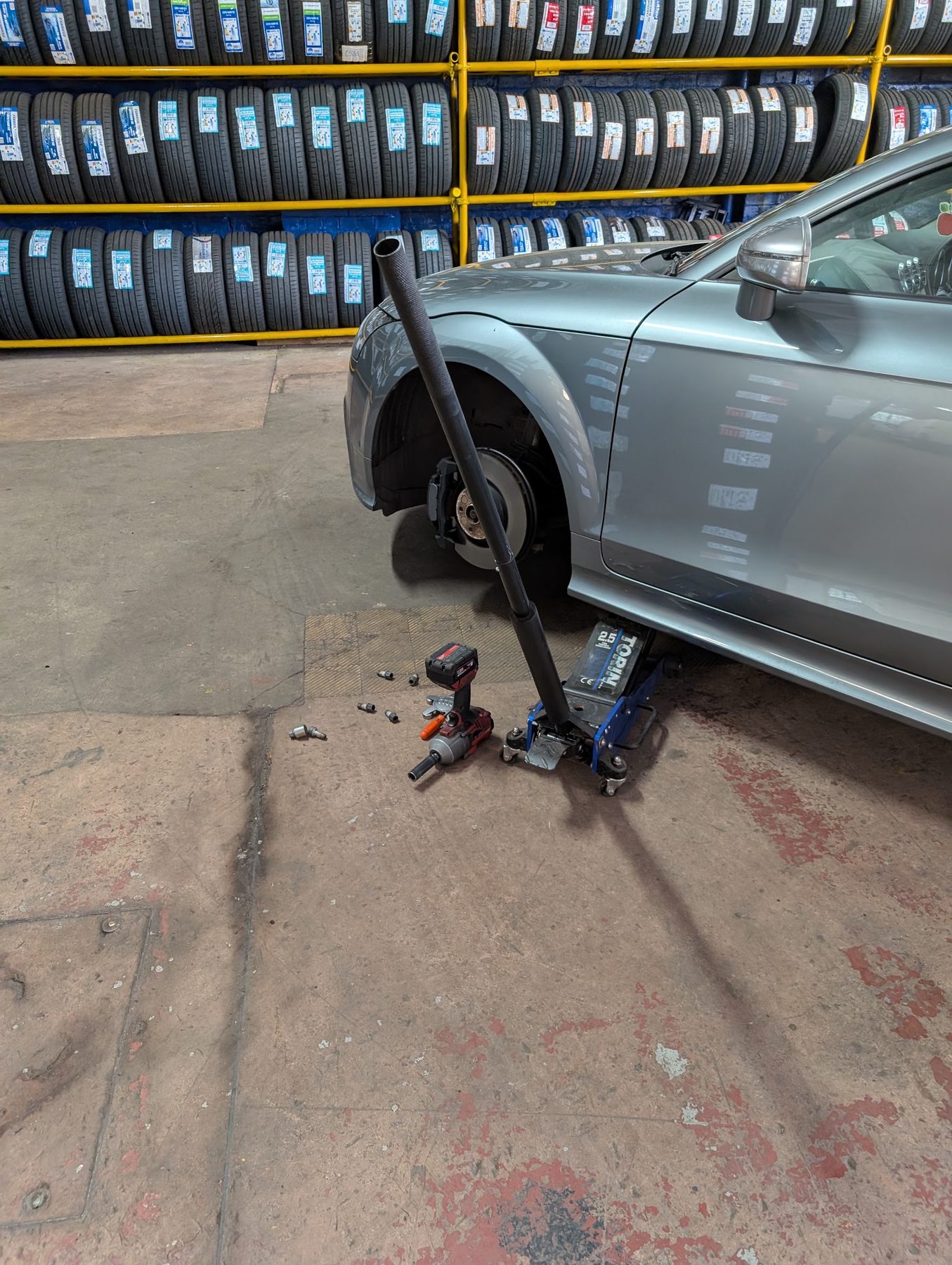 Car raised on a jack having a wheel changed